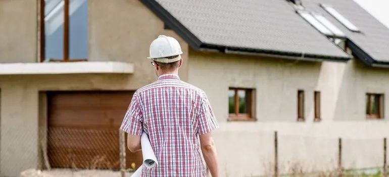 An architect in front of a house. 