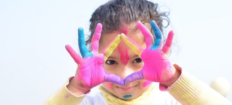 A girl with paint on her hands.