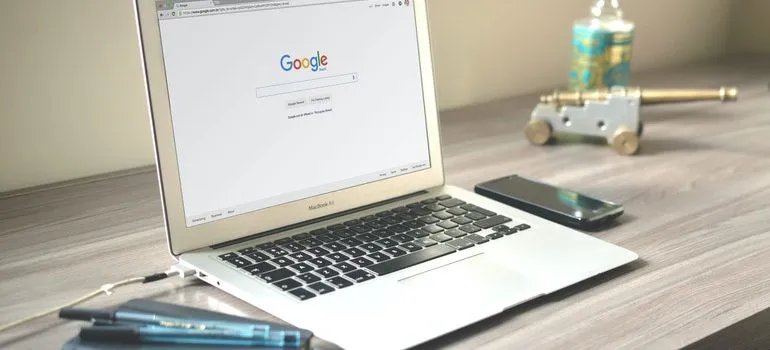 Laptop open to Google homepage.