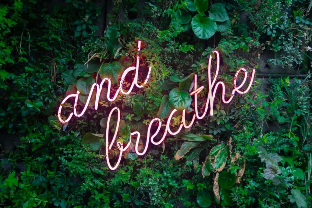 a sign that says "and breathe"
