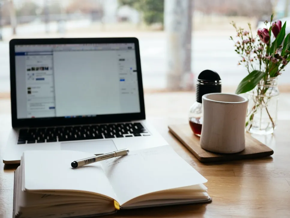 Laptop and open notebook.