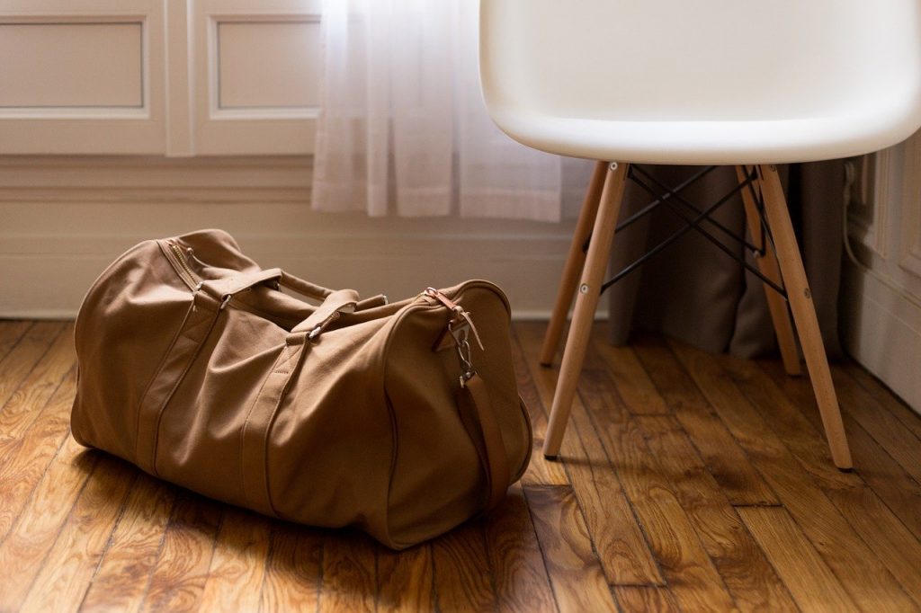 A brown bag next to a chair.