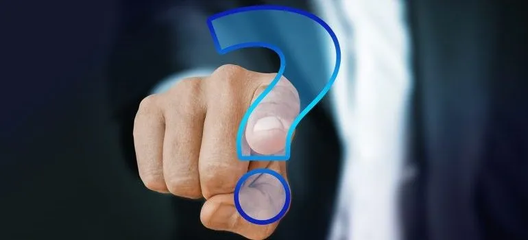 A man pointing to a question mark.
