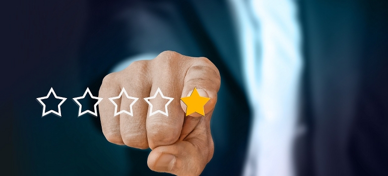 A finger pressing a rating star depicting the importance of moving company reviews