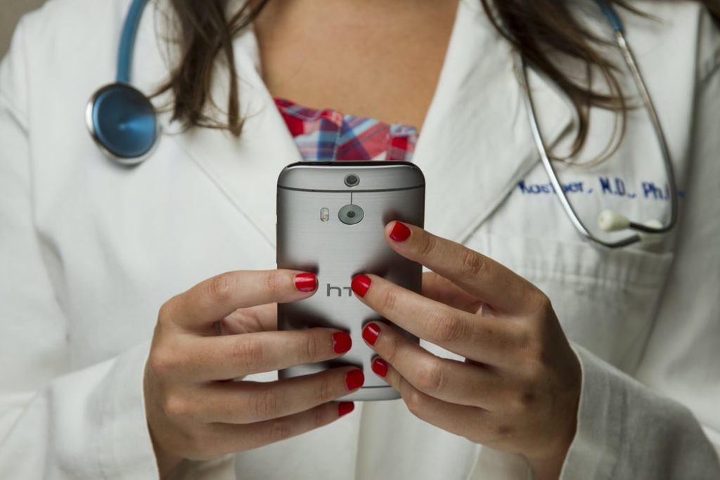 Doctor holding a cellphone.