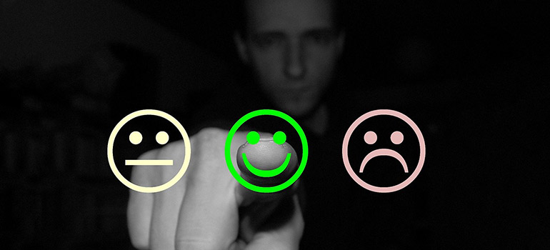 A man pressing a smiley icon depicting moving company rating