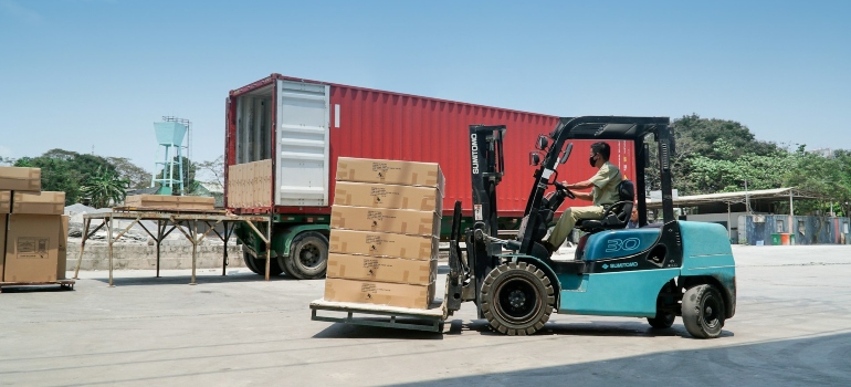 A man driving blue and black utility truck considering the pros and cons of air cargo shipping