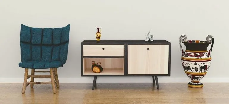 A chair, an end table, and a vase.