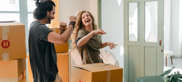 Happy couple packing items after they find good long-term storage solutions
