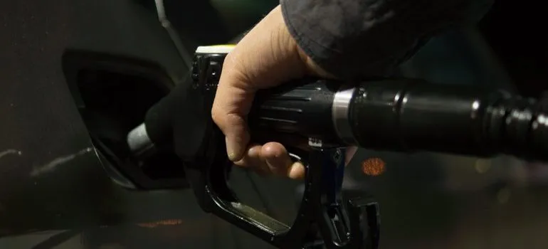 Person filling up a gas tank.