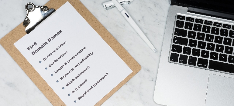a checklist of how to find a domain name and a laptop