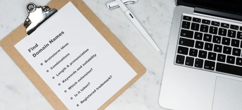 a checklist of how to find a domain name and a laptop