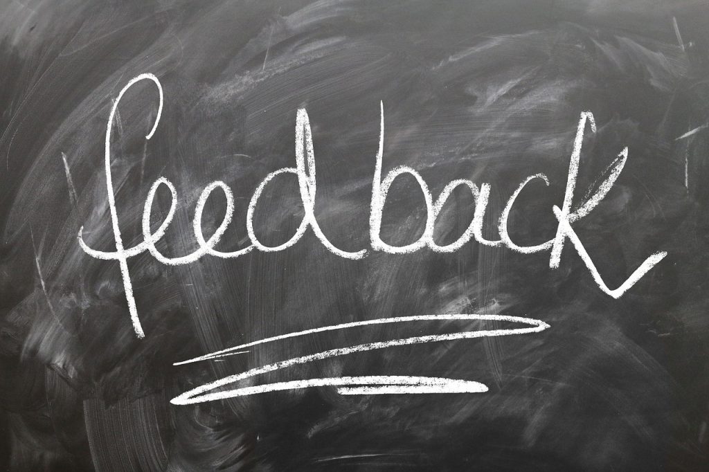 a chalkboard sign telling you to share feedback with your movers