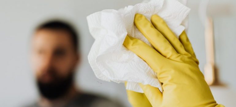 Person cleaning a mirror