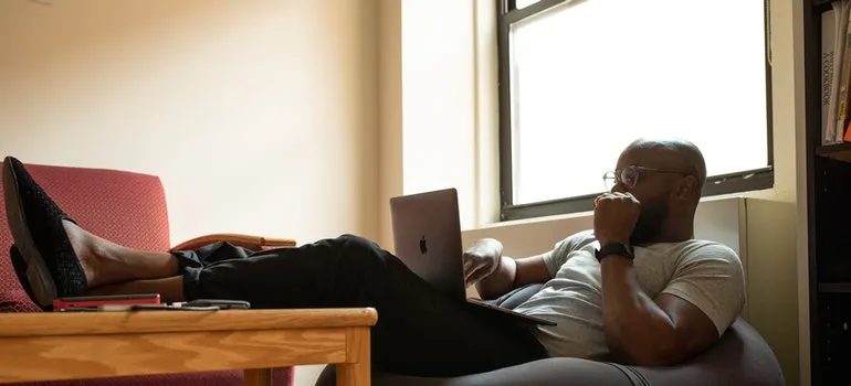 A man assessing his business' storage needs on his laptop.
