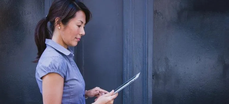 A woman holding a tablet.