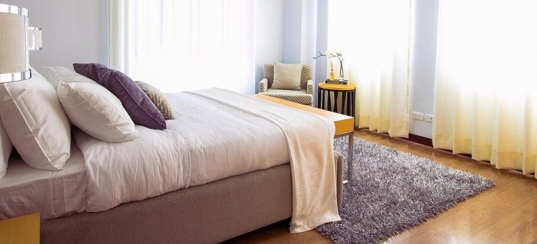 A bed in a living room.
