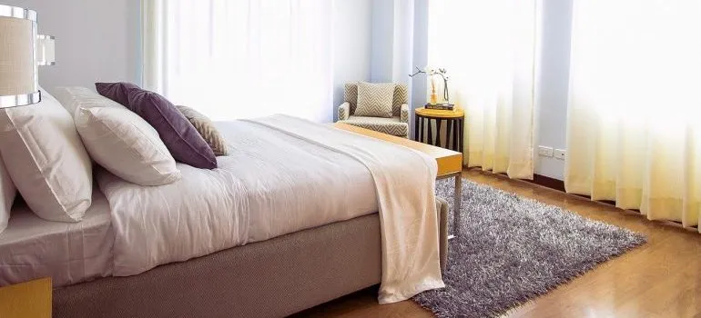 A bed in a living room. 