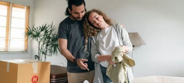 Couple packing together to make moving in together simpler