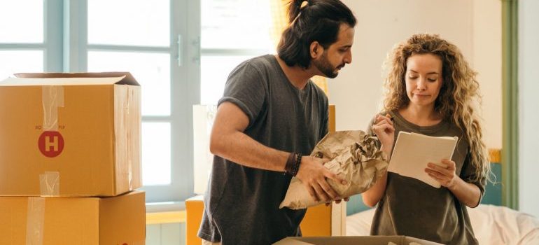 Couple making a list after learning about the benefits of doing an inventory of your storage