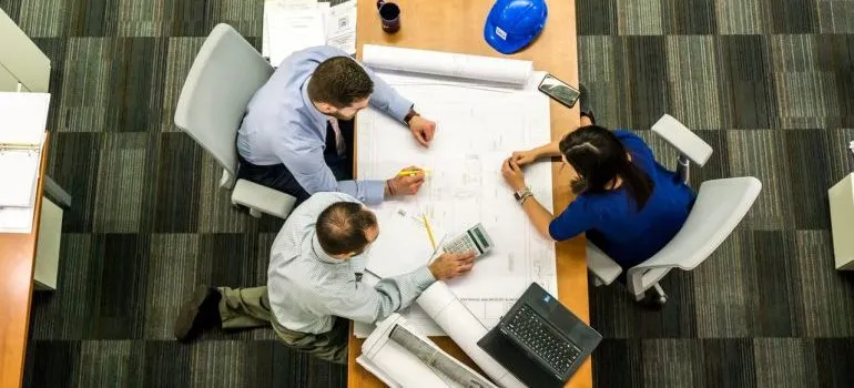 People making a plan for relocating a hotel