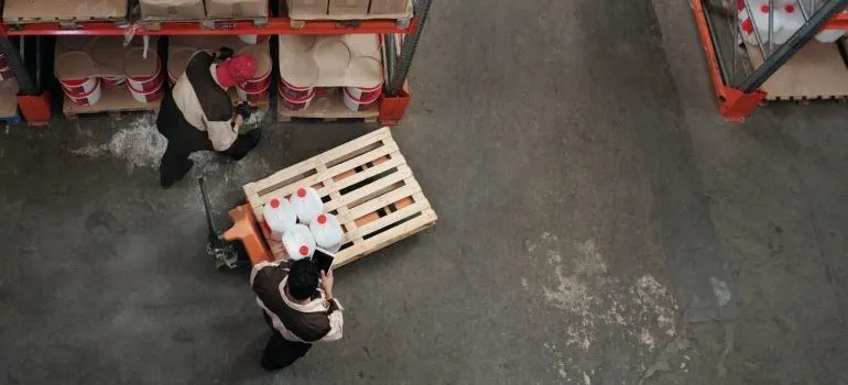 Men checking items inside a warehouse