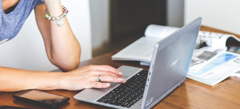 A woman working on a laptop.