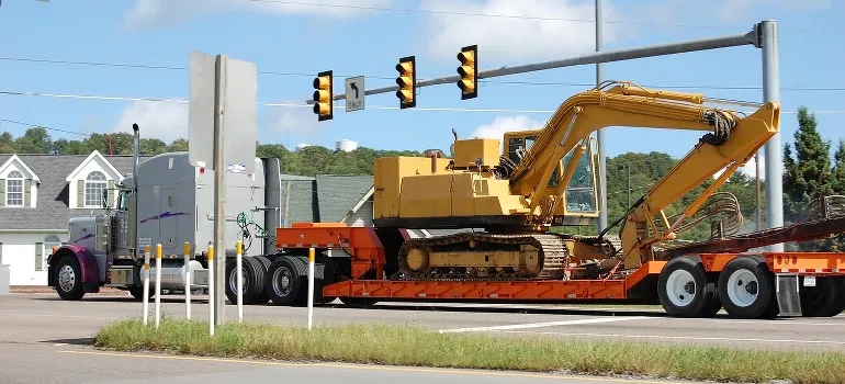 truck carrying a large digger