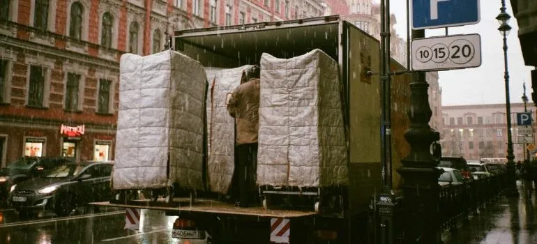 Truck being loaded while it's raining.