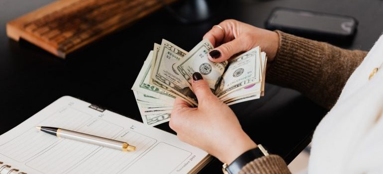 Woman planning a budget after learning when movers can charge you extra