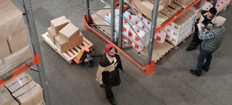 Three me inside a warehouse