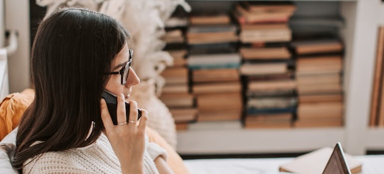 A woman talking on smartphone how to plan a move in less than a week.