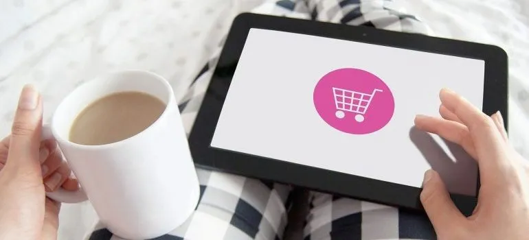 A woman doing online shopping on a tablet.
