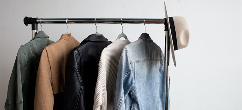 A hanger with a couple of jackets on it