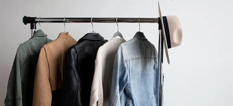 A hanger with a couple of jackets on it