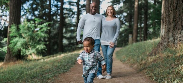 A family of three in the woods, enjoying the benefits of living in Meridian ID.