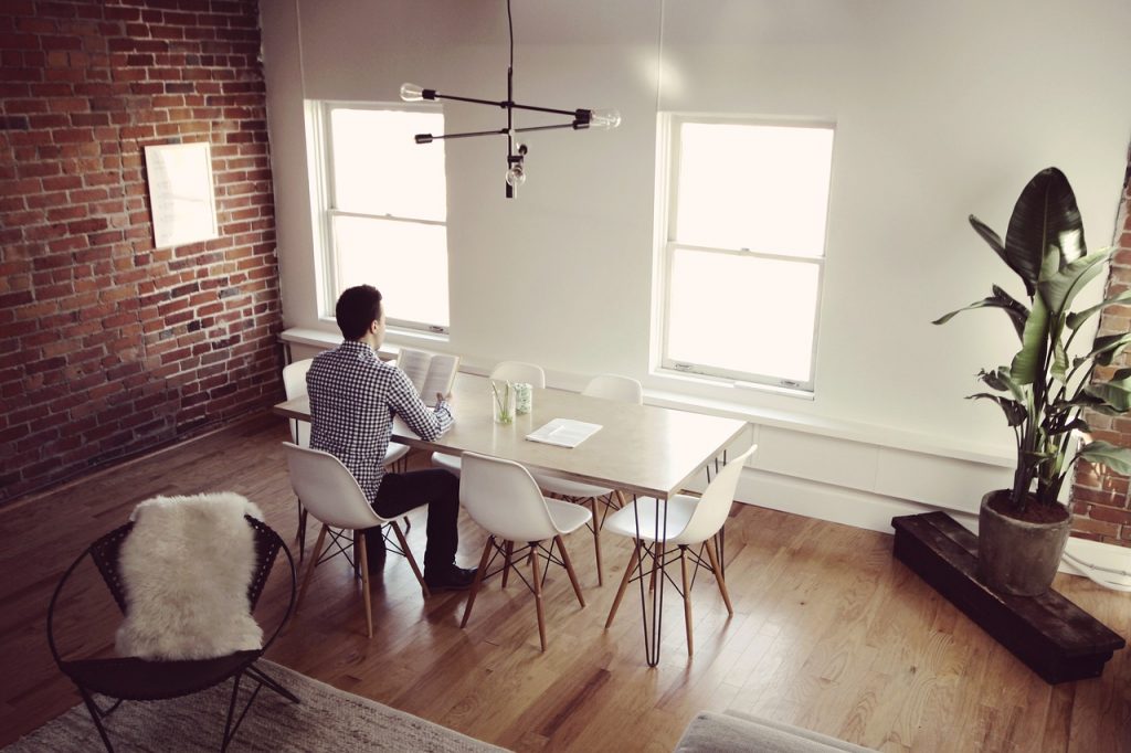 A man sitting in his clutter-free living room