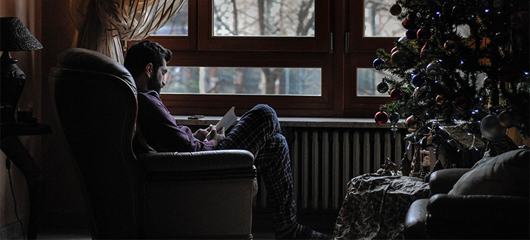 A man reading a book in his reading nook