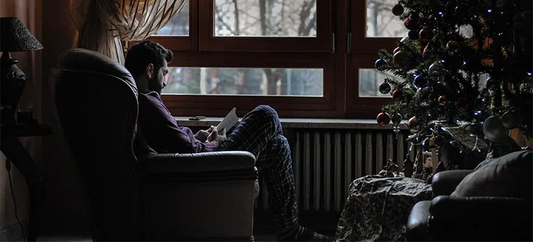 A man reading a book in his reading nook