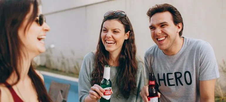 Friends smiling and drinking