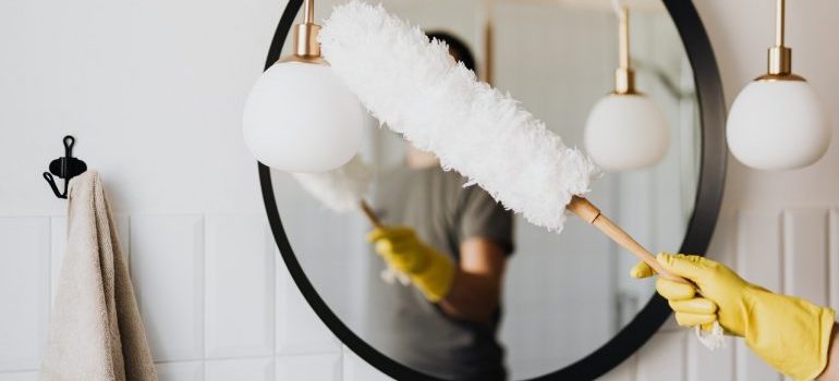 Person dusting a bathroom