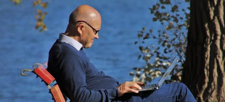 Elderly man using laptop.