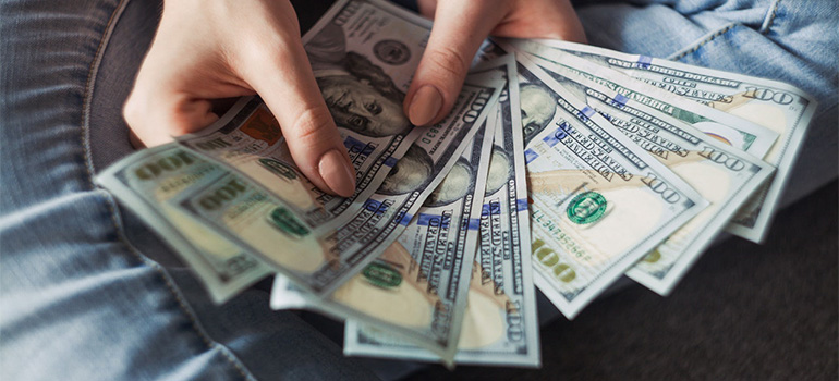 A woman holding cash
