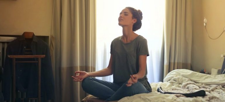 A woman meditating.