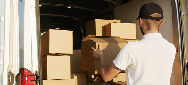 A mover carrying a box into a truck
