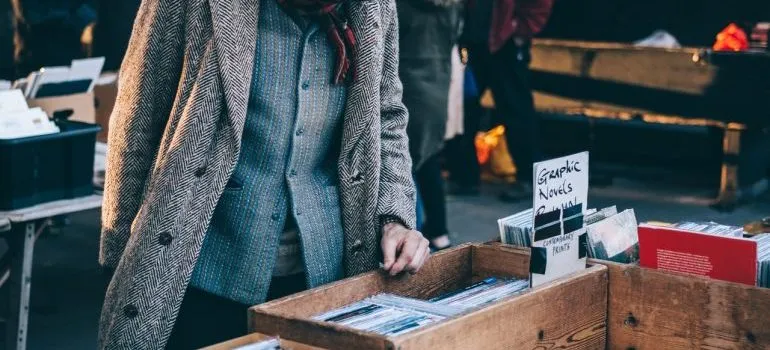 A man looking through records at a garage sale.