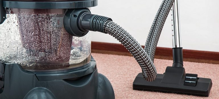 A vacuum cleaner on a rug.
