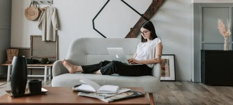 A woman making a moving plan on her laptop.