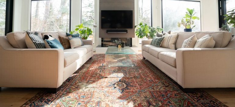 A colorful area rug in a living room.