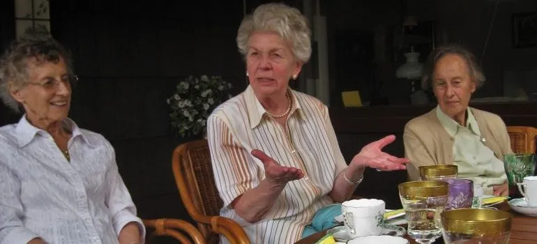 Three women taking about downsizing after retirement.